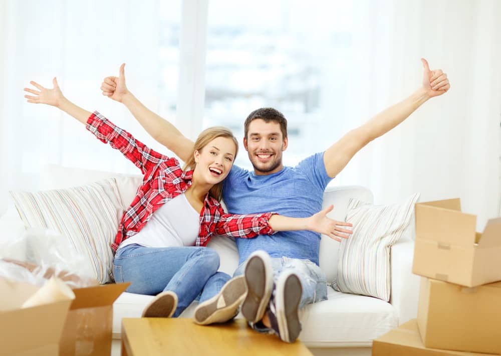 Couple Relaxing On Sofa In New Home